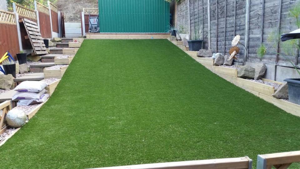 artificial grass installed on a sloped garden